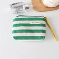 Close-up of green and white striped canvas coin purse with yellow wrist strap - Green Stripe