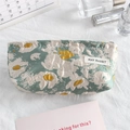 Close-up of floral jacquard fabric on a mini cosmetic bag with May Rabbit label - Egg Yolk Flower