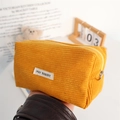 Close-up of bright yellow corduroy stationery pouch with zip and soft fabric texture - Turmeric