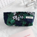 Detailed embroidery on floral jacquard canvas makeup bag with premium woven brand label - Navy Blue Green Flower