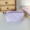 Detail of lavender quilted cosmetic bag showing cute bear stitching and soft texture - Quilted Cat Head Purple