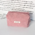 Close-up of pink corduroy makeup bag with MAY RABBIT woven label and metal zipper - Nude Pink