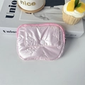 Detail of pink quilted coin purse showing butterfly embossed pattern and front pocket - PU Bow Pink