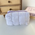 Close-up of quilted light purple makeup bag with soft texture and zip closure detail - Quilted Square Purple