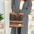 Detail shot of the plush fabric texture and geometric ethnic patterns on the brown tote bag - Retro Figure