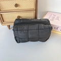 Detail shot of the black quilted fabric texture and zipper on the large makeup bag - Quilted Square Black