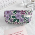 Detail of floral jacquard fabric makeup bag with silver zipper and woven logo tag - White Base Purple Floral