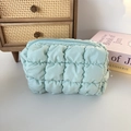 Detailed texture of mint green quilted makeup bag with soft bubble puff fabric and zipper - Bubble Check Green