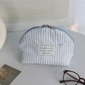 Dettaglio della borsa cosmetica a righe blu con fiocco ricamato e doppia zip in metallo - Bianco a Righe Blu Fiocco Blu