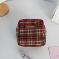 Macro shot of wool plaid makeup bag with premium metal zipper and leather brand tag - Woolen Red Plaid (Leather Label)