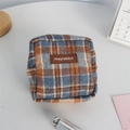 Detail of blue and brown checkered wool storage pouch with zipper and leather brand logo - Woolen Blue Plaid (Leather Label)