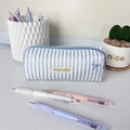 Close-up of blue striped fabric pencil case featuring delicate butterfly embroidery detail - White Blue Stripe Blue Bow