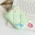 Detail of mint green quilted makeup bag with pink bow and ribbon on laptop keyboard - Fruit Green Plaid