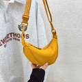 Detail of adjustable strap and matte buckle on a bright yellow nylon crescent crossbody bag - Yellow