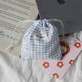 Detail of blue and white checkered drawstring bag with a May Rabbit woven brand label - White Plaid