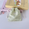 Detail of yellow and blue checkered drawstring storage bag with May Rabbit label - Yellow Plaid