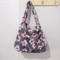 Detail of plush tote bag with grey base and pink flower pattern hanging on wall - Plush Flower Pink