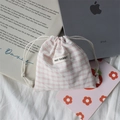 Detailed view of pink plaid drawstring storage bag with May Rabbit label on fabric - Pink Plaid