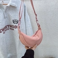Detail of pink half-moon nylon crossbody bag showing the wrinkled texture and zipper - Lotus Pink