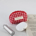 Detail of red and white checkered plush coin purse with gold zipper and brand label - Woolen Square Red Plaid