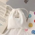 Detailed close-up of white waffle texture drawstring storage bag for cosmetics - Polyester Waffle White