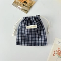 Detailed view of navy blue gingham cotton drawstring bag with mayrabbit logo patch - Navy Plaid
