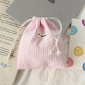 Detailed shot of pink waffle weave drawstring pouch with May Rabbit label on a desk - Polyester Waffle Light Pink