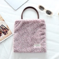 Flat lay of leopard print faux fur tote bag with brown leather handles and chic accessories - Plush Purple Pink Leopard Print