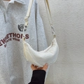 Chic cream-white half-moon crossbody bag with adjustable strap and water-resistant nylon fabric - White