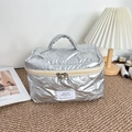 Detailed close-up of silver quilted makeup bag with metallic bunny pattern and top handle - Small Bow Silver
