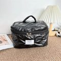Close-up of black quilted makeup bag with embossed bunny patterns and double zippers - Small Bowknot Black