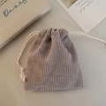 Detail shot of mauve corduroy drawstring pouch with white cotton rope closure and soft texture - Gray