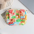 Close-up of cute floral quilted storage pouch with cartoon bear prints and metal zipper - Graffiti