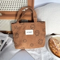 Close-up of brown corduroy tote bag with black smiley patterns and May Rabbit logo - Brown Smile