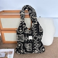 Close-up of geometric plush tote bag on a rattan cabinet in a cozy home setting - Plush Ethnic Style Black Totem