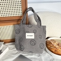 Detail of grey corduroy handbag with black smiley face prints and woven label - Gray Smiley Face