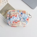 Detailed macro view of quilted floral cotton pouch with snap pocket and metal keyring - Rabbit Family