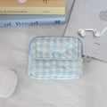 Detailed view of blue checkered quilted pouch with snap closure and metal keyring attachment - Checkered Heart