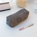 Detailed close-up of gray corduroy pencil case featuring embroidered smile face patterns - Gray Smiley Face