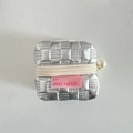 Macro view of silver PU leather quilted headphone case with pearl zipper and pink label - Silver Small Grid