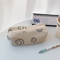 Detail view of corduroy pencil case with smiley face print and zip closure - Creamy White Smiley Face