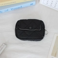 Close-up of black quilted floral mini pouch with flip cover and metal hook detail - Black Embroidered Bow