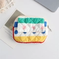 Detail of multi-color quilted fabric pouch with secure zipper and resin button closure - Colorful Stripes and Dots