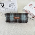 Close-up of vintage plaid wool pencil case with brown leather tag and zipper closure - Woolen Blue Large Plaid