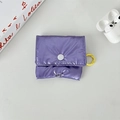 Macro shot of purple quilted puffer storage case for AirPods with yellow carabiner clip - Small / Purple (Glossy)