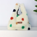 Detail shot of plush white faux fur handbag with vibrant multi-colored polka dots pattern - Plush Colorful Polka Dots