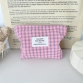 Detail of pink and blue checkered fabric cosmetic bag with a small woven brand label - Blue Pink Plaid