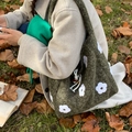 Dark green plush shoulder bag with white flower embroidery and drawstring detail - Green