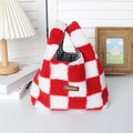 Close-up of red and white checkered plush handbag with branded label and inner lining - Red Checkerboard