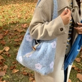 Light blue plush tote bag with white floral embroidery and wooden button closure - Light Blue